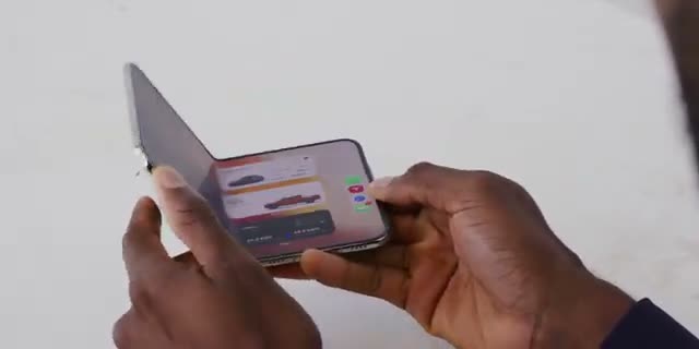 iPhone Duo half-open in hand, from MKBHD's review