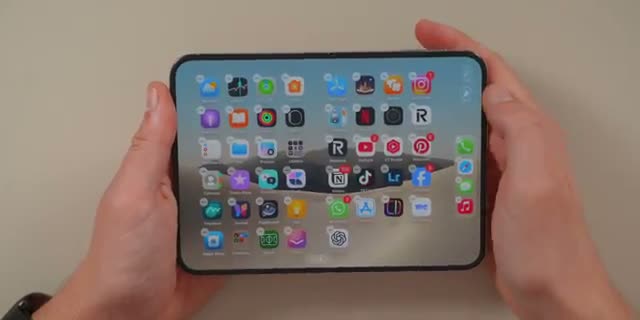 Nikias Molina holding the open Duo showing its full app grid