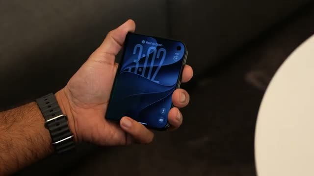 The Duo's small cover screen in hand — The Verge